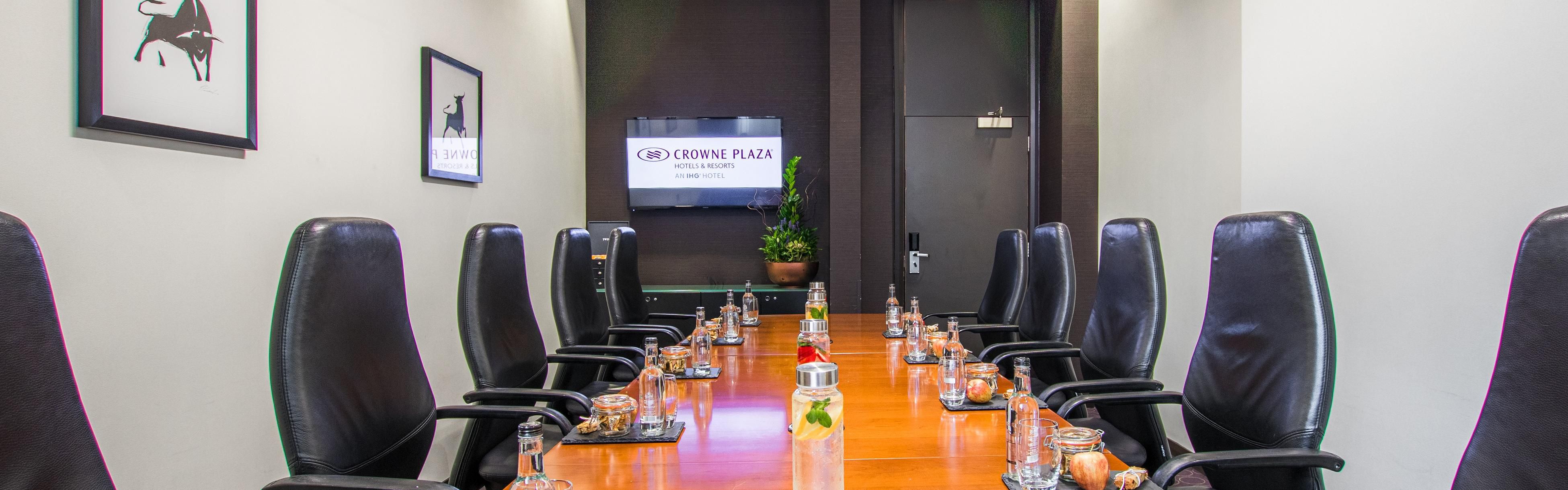 Meeting room at Crowne Plaza Birmingham with sleek table, ideal for corporate events.