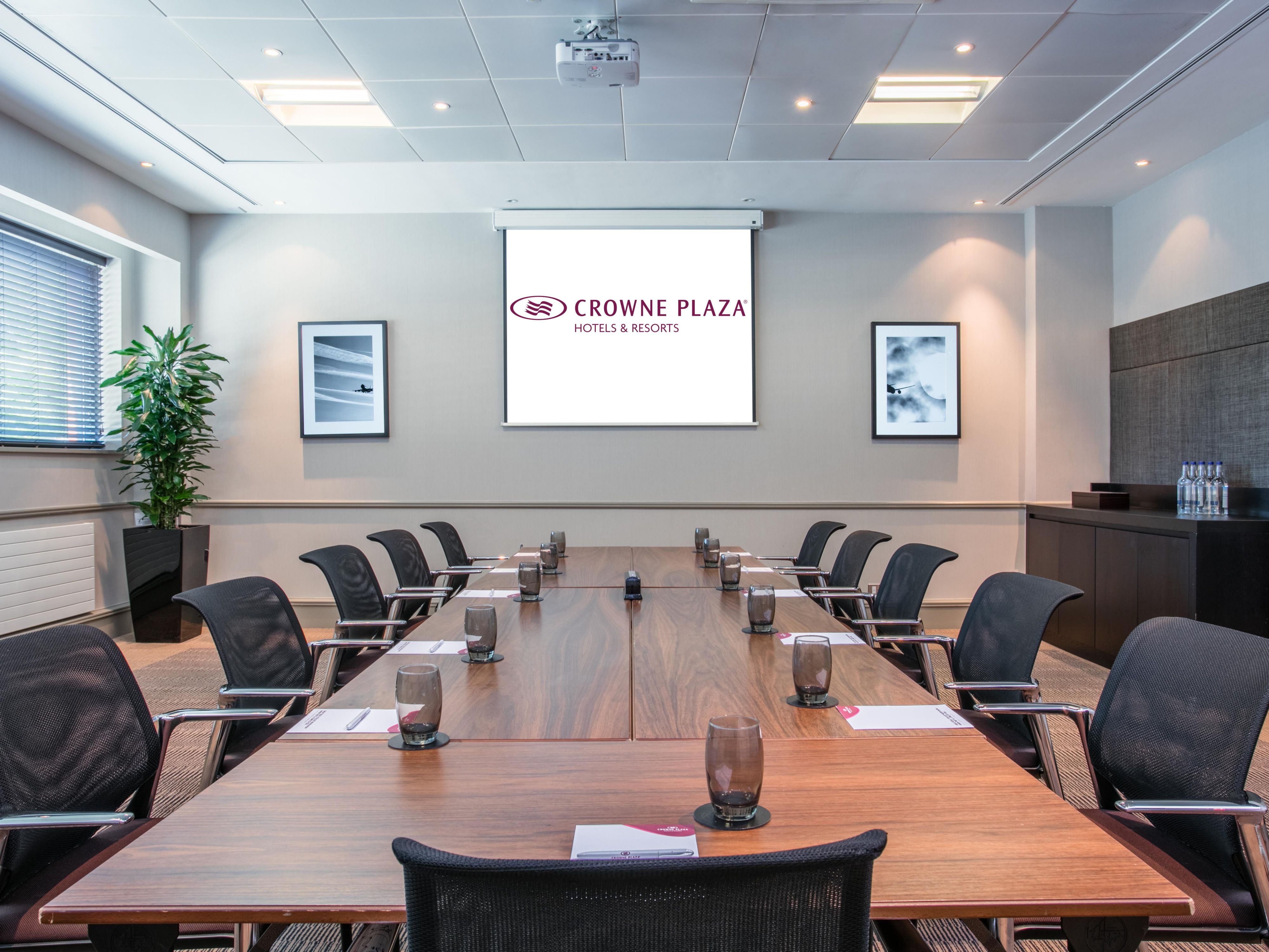 Conference center meeting room with polished table, ideal for corporate events and workshops.