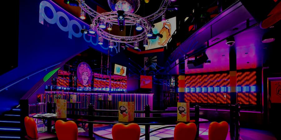 Vibrant Popworld Birmingham lounge with colorful lighting for parties and events.