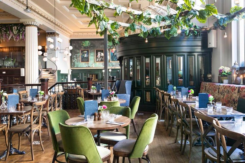 Event space at The Lost & Found Birmingham with floral centerpieces and warm lighting.