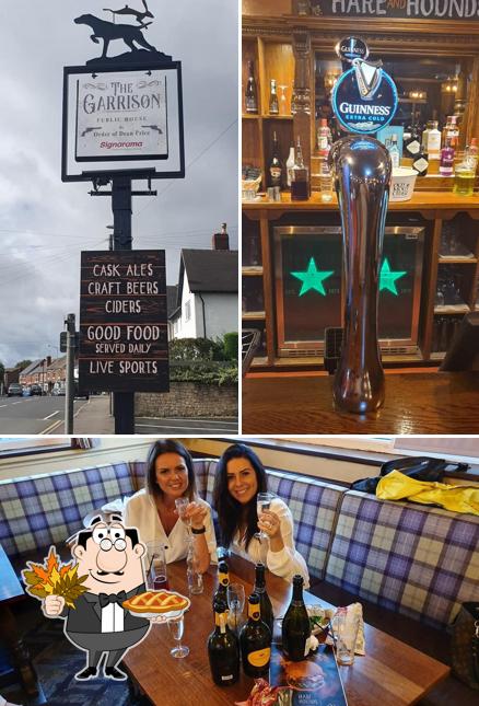 Cozy pub interior with guests toasting drinks, ideal for casual gatherings and live sports.