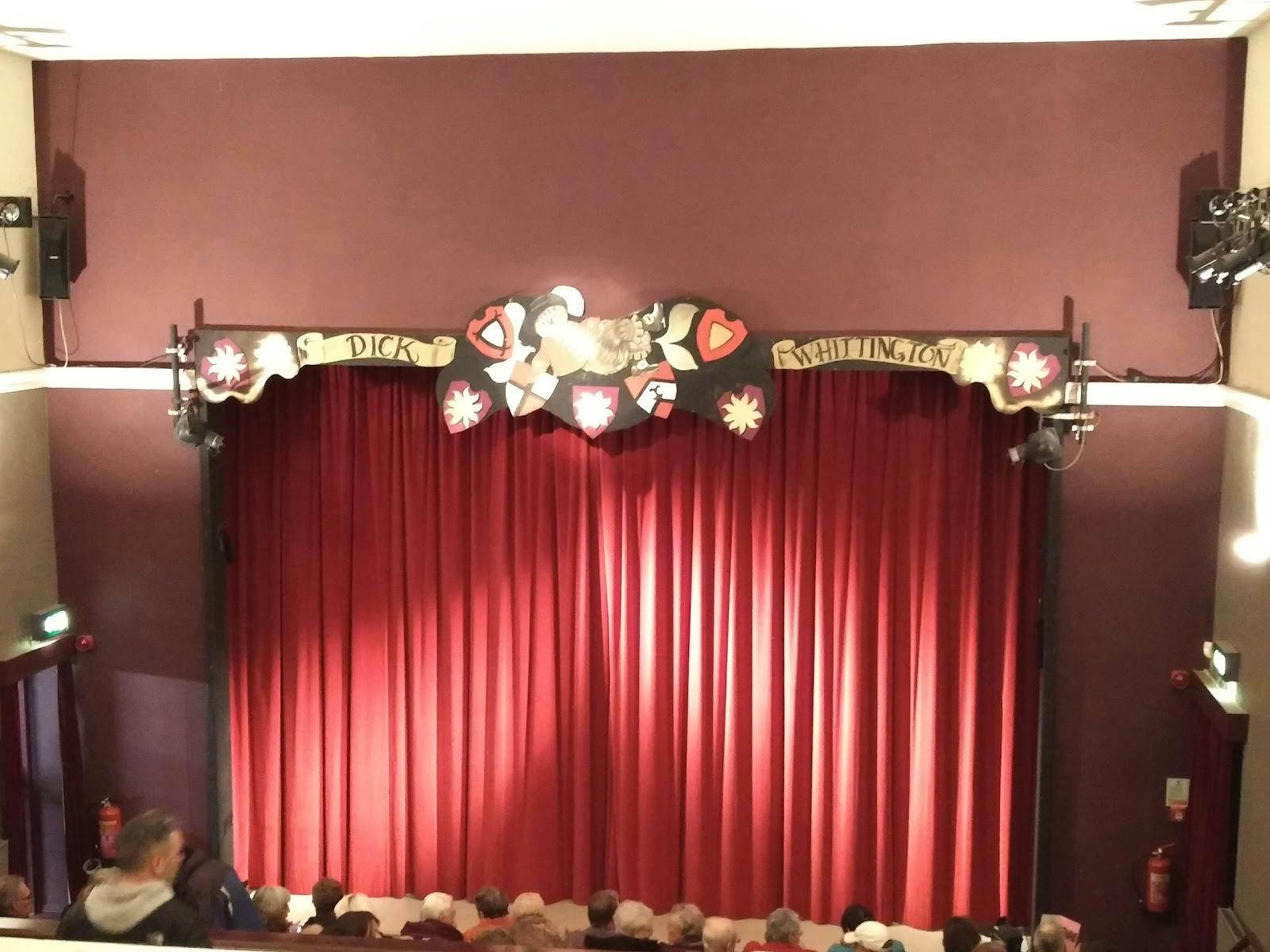 Studio Theatre stage with red curtain, perfect for intimate performances and events.