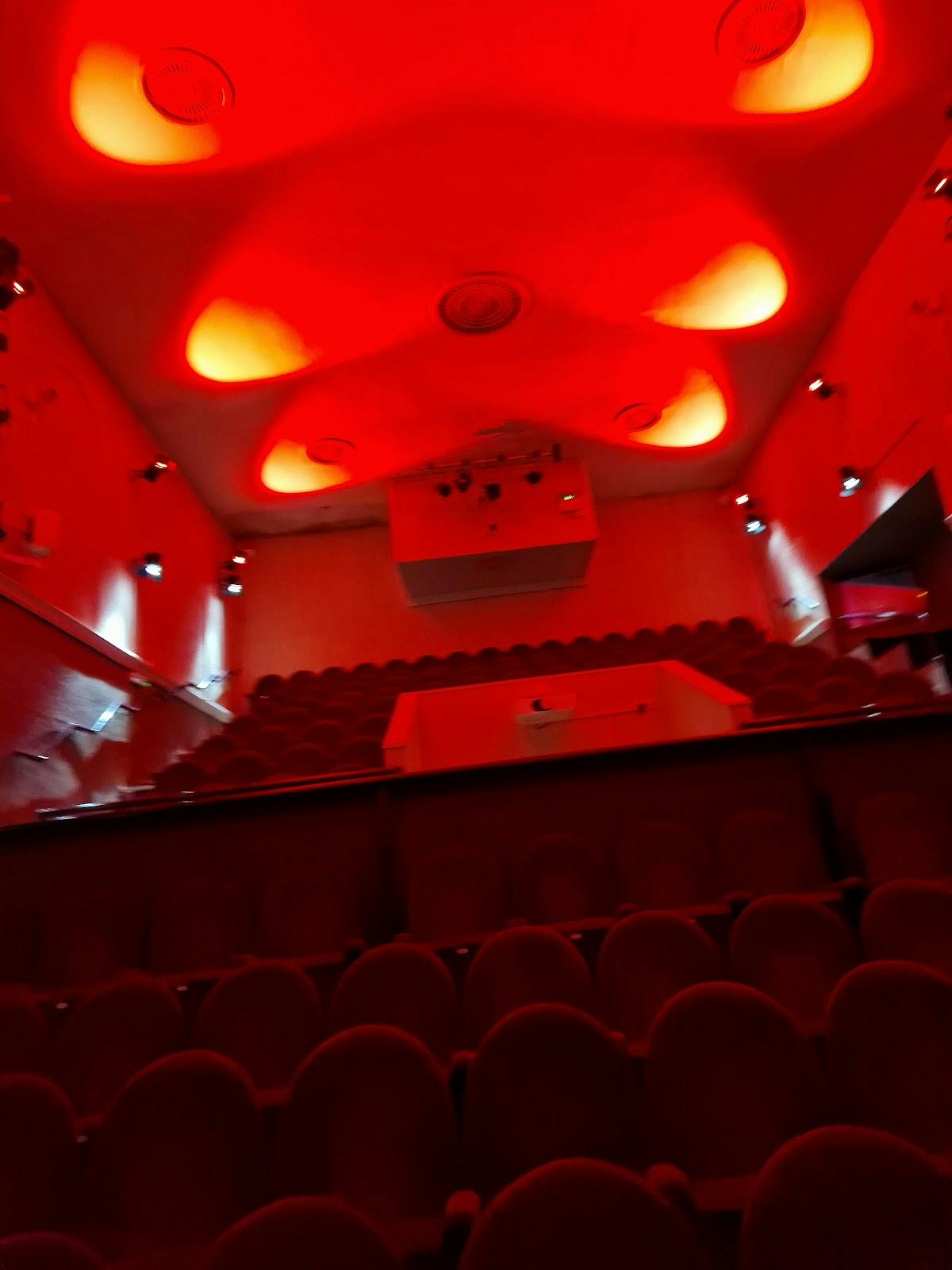 Studio Theatre in Oldbury: tiered seating and dramatic red lighting for performances.