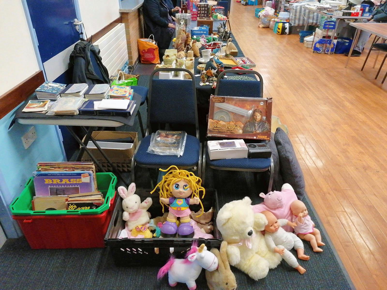Community event setup in Layca Centre with toys and books for a flea market.