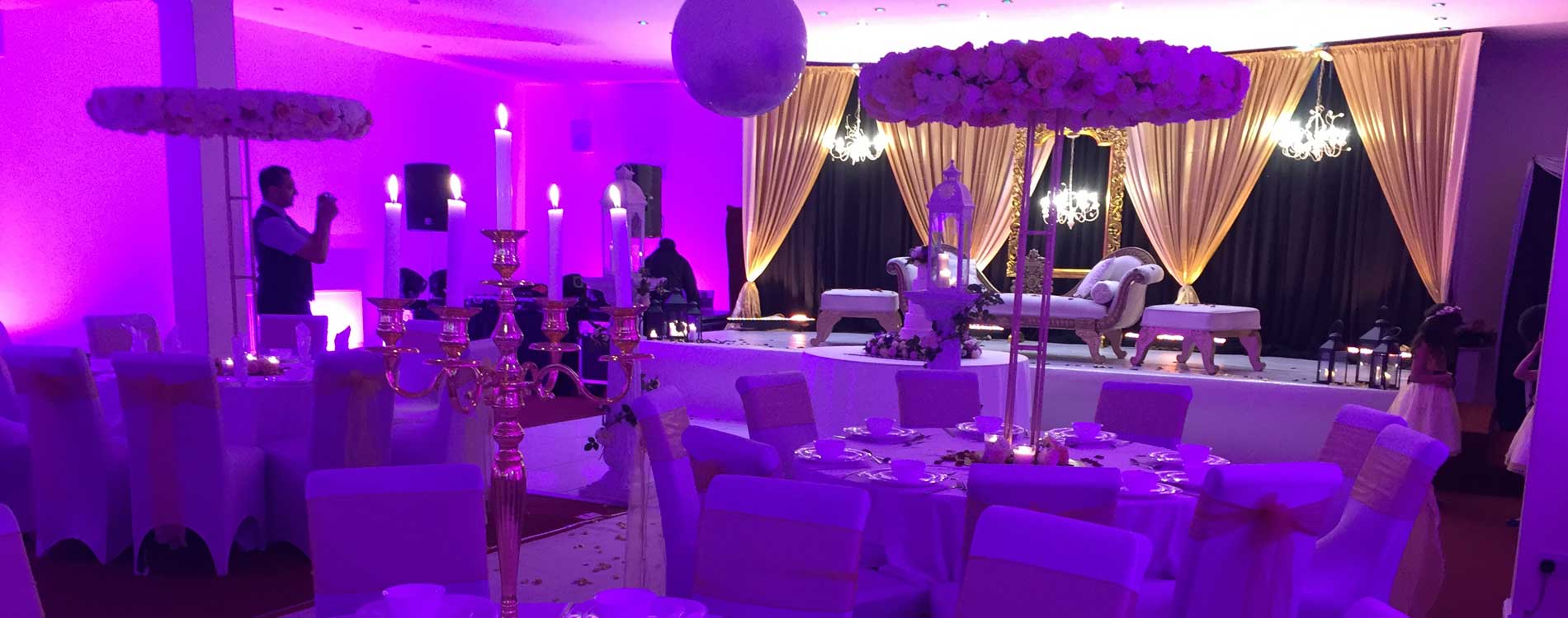Elegant banquet hall with purple lighting, perfect for weddings and gala events.