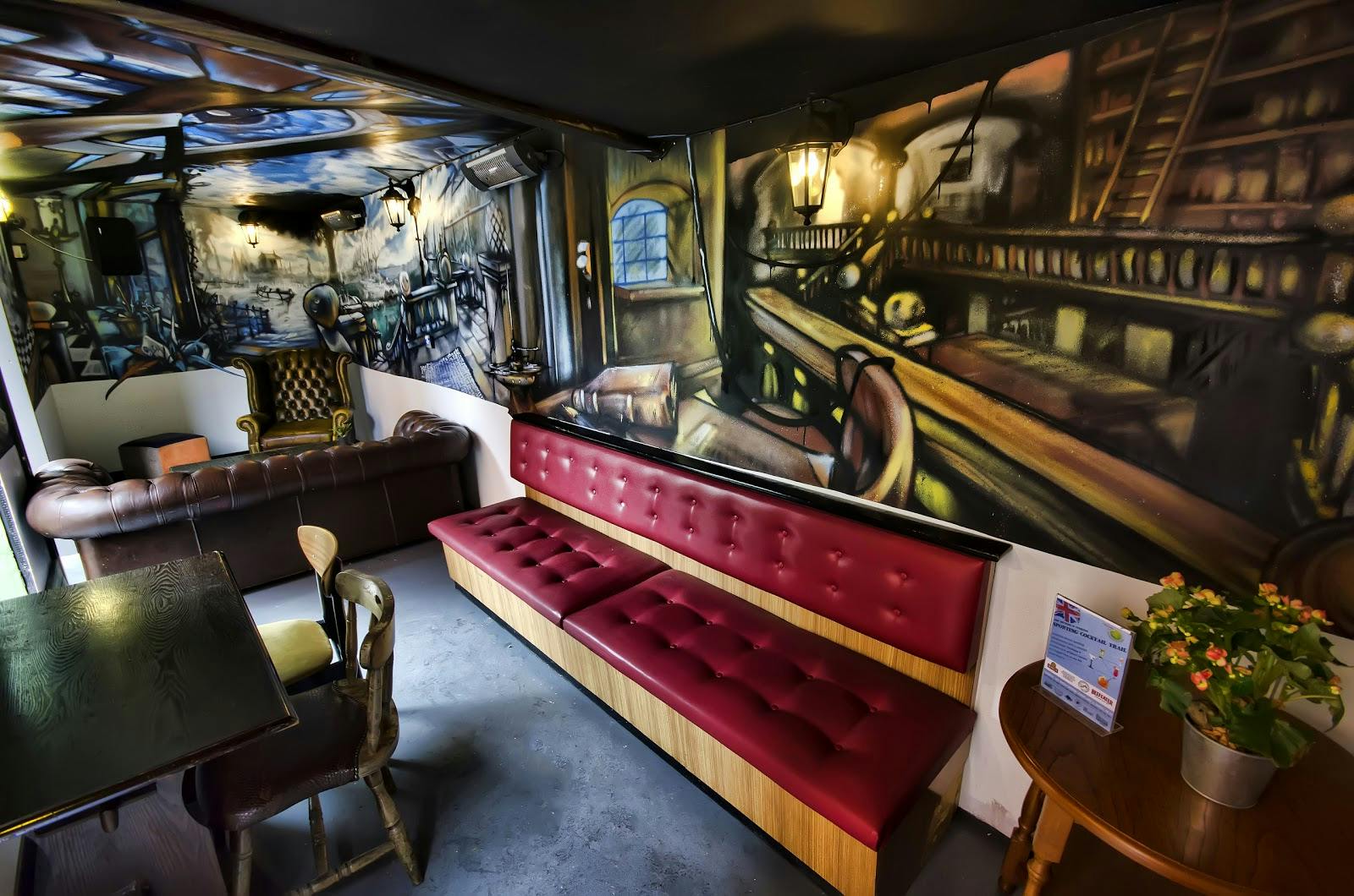 Garden Area at Rose Villa Tavern with vibrant mural art for creative meetings and networking.