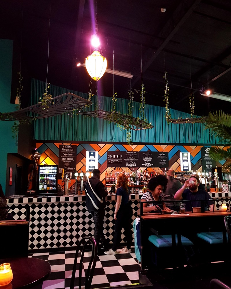 Vibrant Digbeth Dining Club bar with colorful decor for casual networking events.