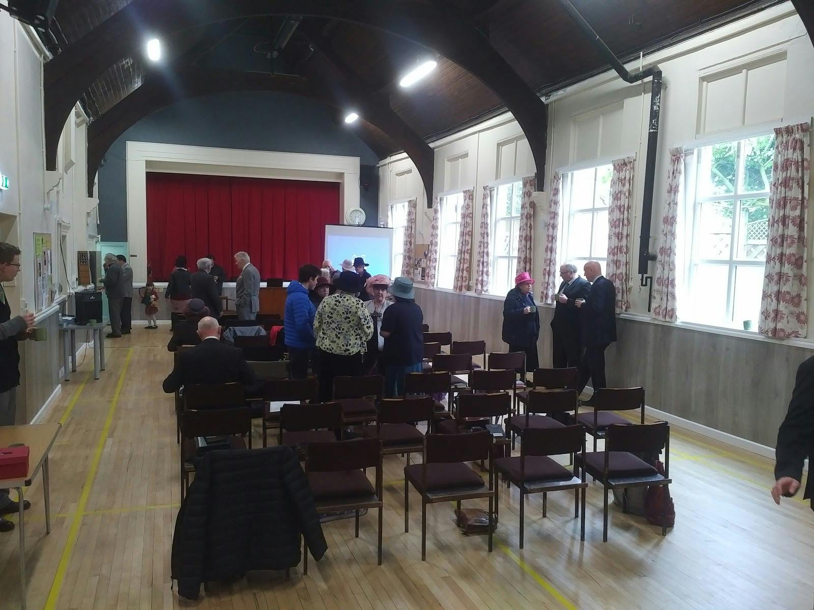 Earlswood Village Hall Main Hall setup for community networking event with red curtains.
