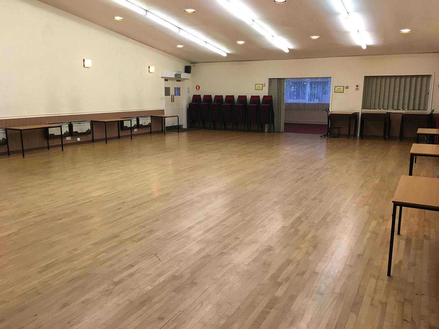 Versatile Knowle Village Hall with spacious wooden floor for events and gatherings.