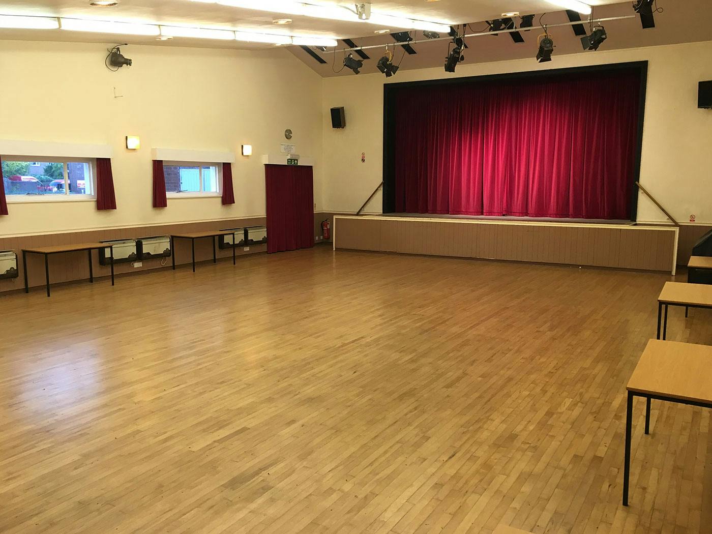Versatile Knowle Village Hall with polished wooden floor for events, meetings, and workshops.