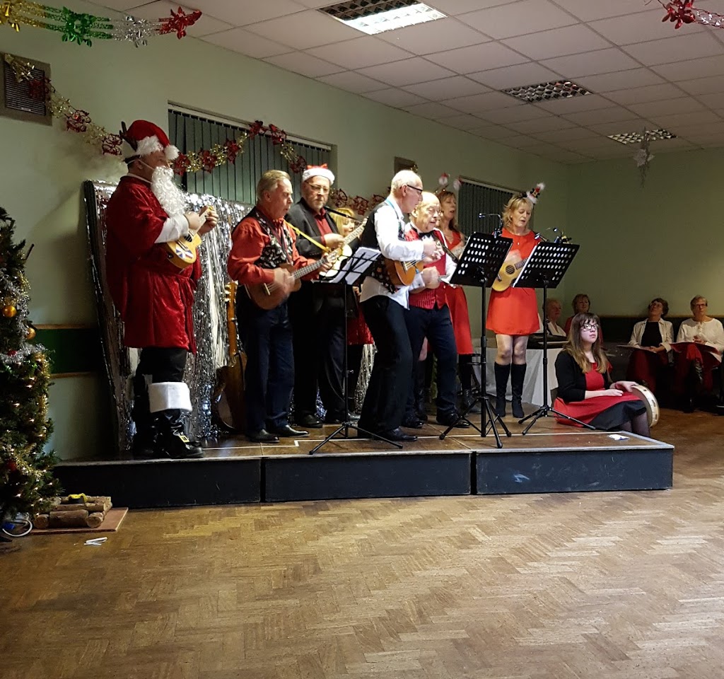 Festive musical performance at Cheswick Green Village Hall during holiday event.
