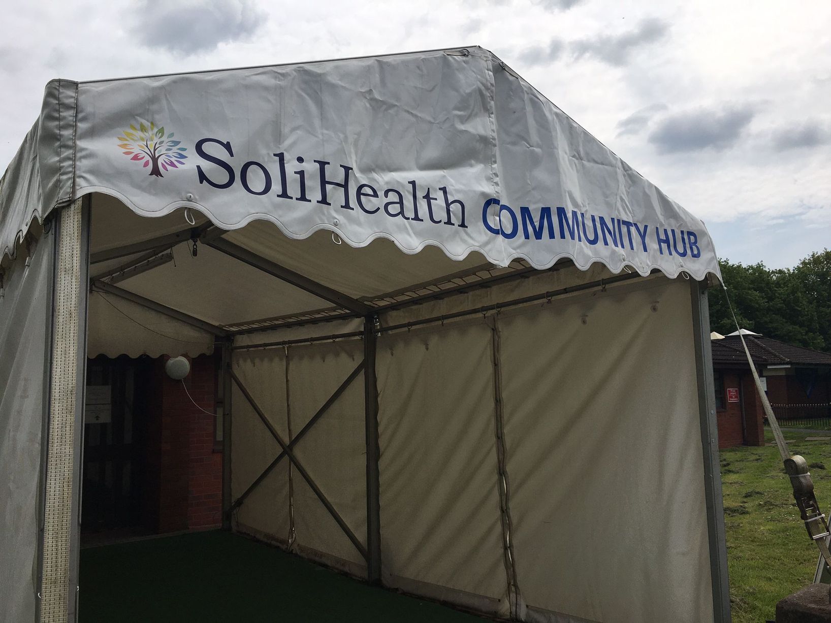 SoliHealth Community Hub tent for outdoor events and wellness activities in Shirley.