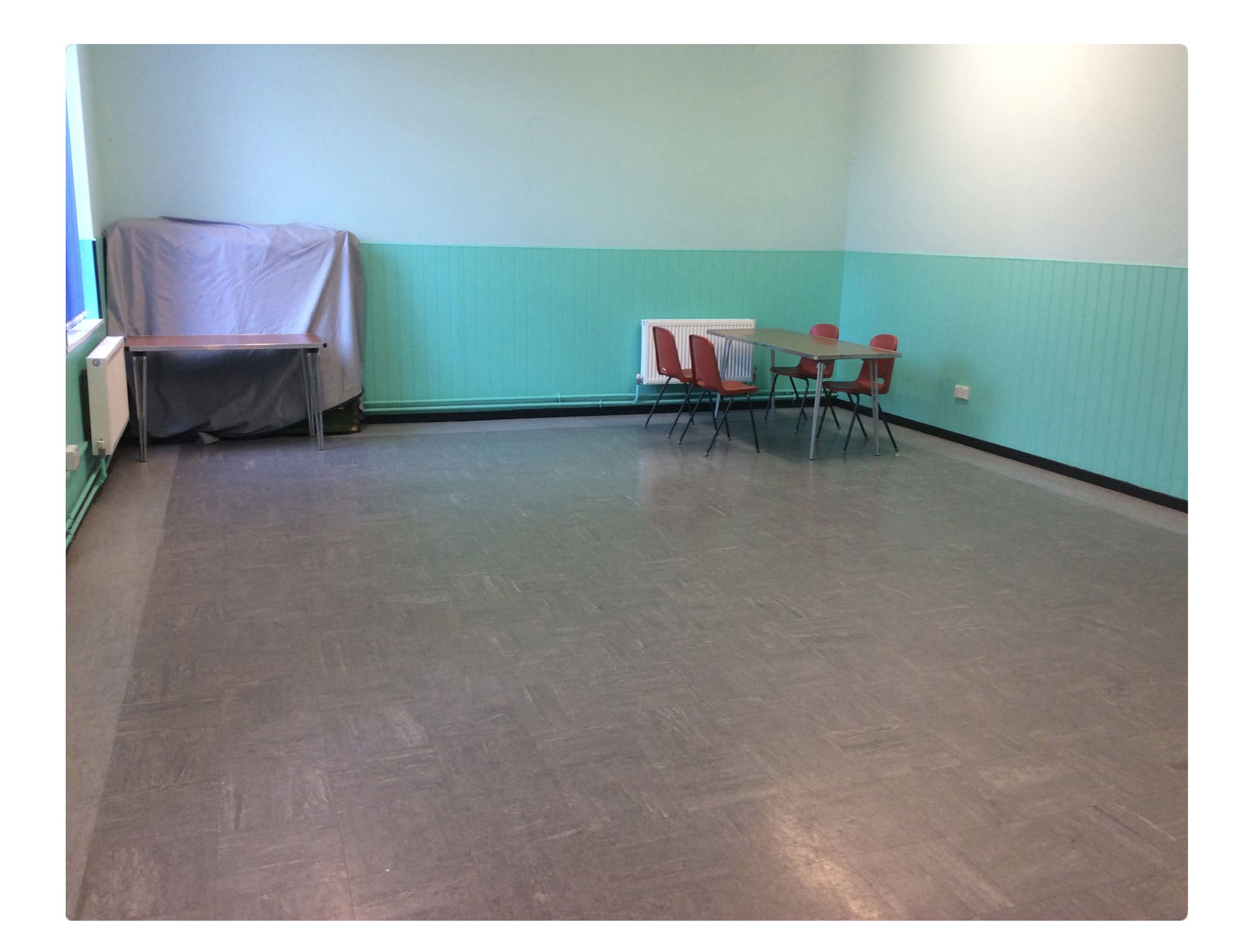Sparsely furnished meeting room at Quinborne Community Centre for small events.