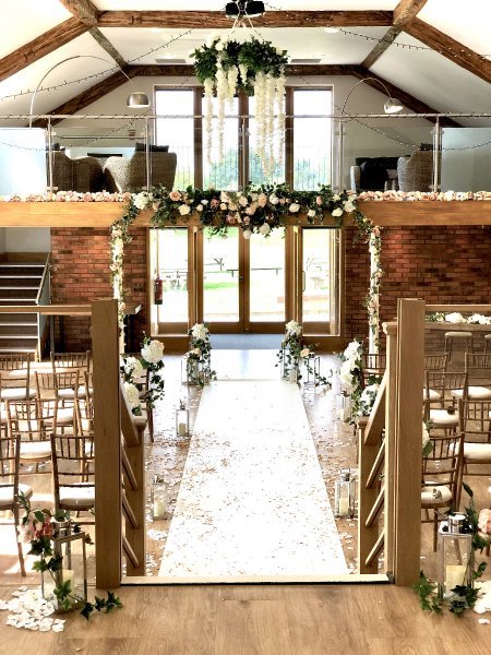 Elegant wedding ceremony space with floral decor in Wootton Park function room.