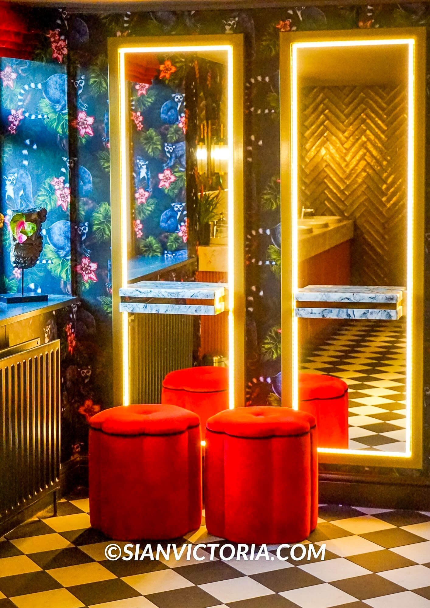 Vibrant gastropub interior with floral wallpaper, perfect for networking events.