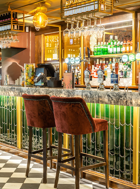 Stylish bar with marble countertop, perfect for networking events and cocktail receptions.