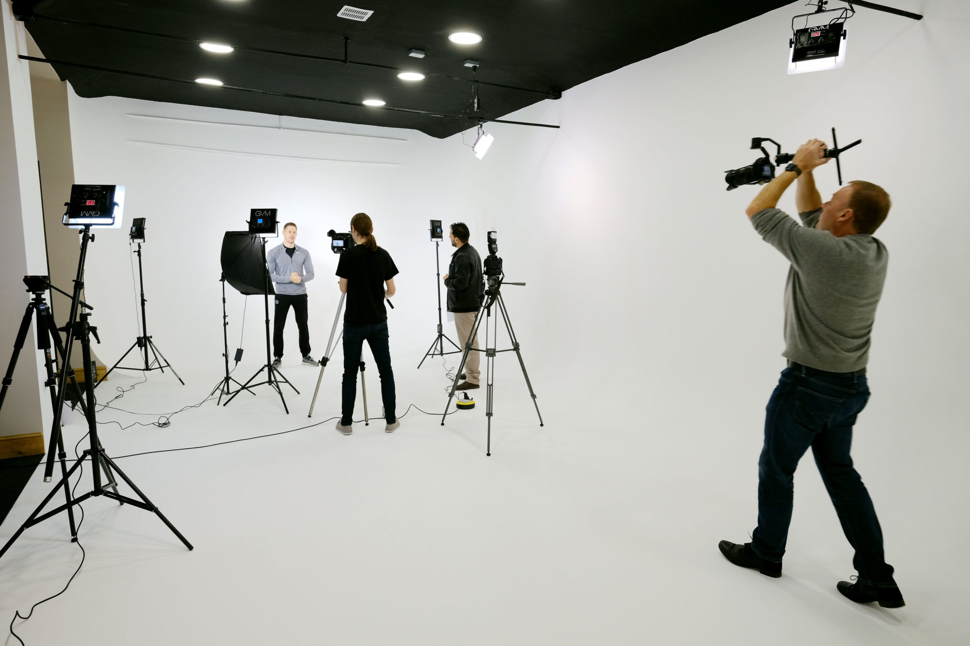 Professional video shoot setup in clean studio for webinars and promotional videos.
