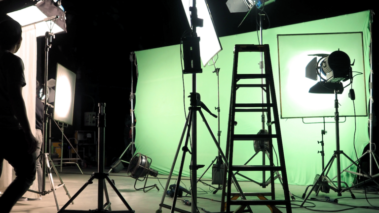 Recording studio with green screen and lighting for high-quality video production.