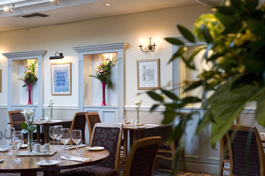 Stylish restaurant event space in Westmead Hotel with elegant tables and floral decor.