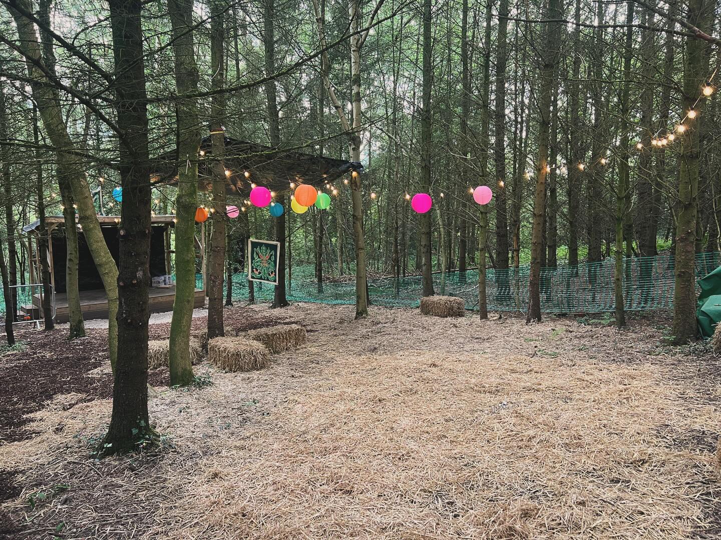 Woodland STAGE at The Strines Nightingale, a rustic outdoor event space with string lights.