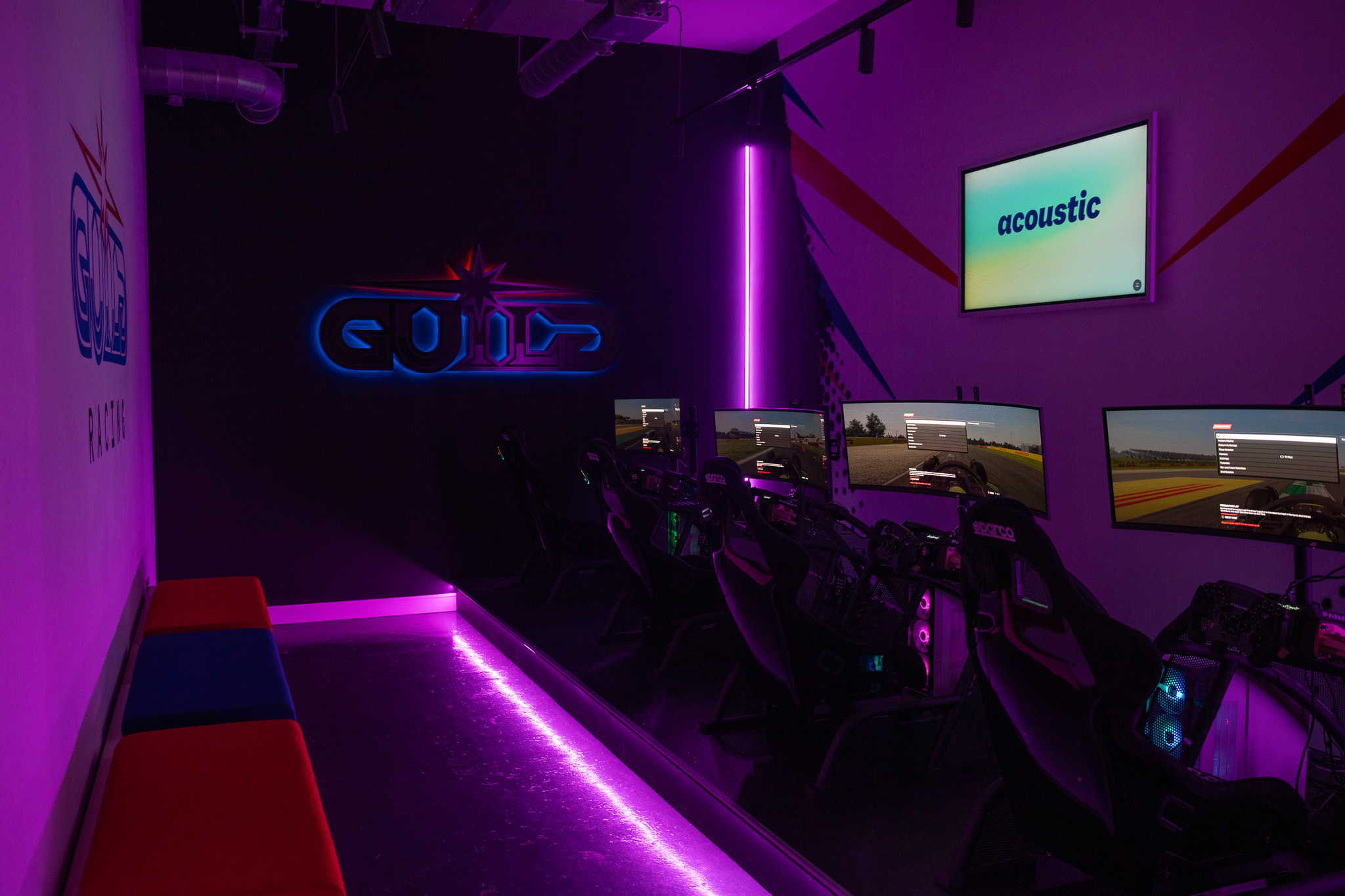 Modern gaming lounge with neon lighting for team-building events and tech gatherings.