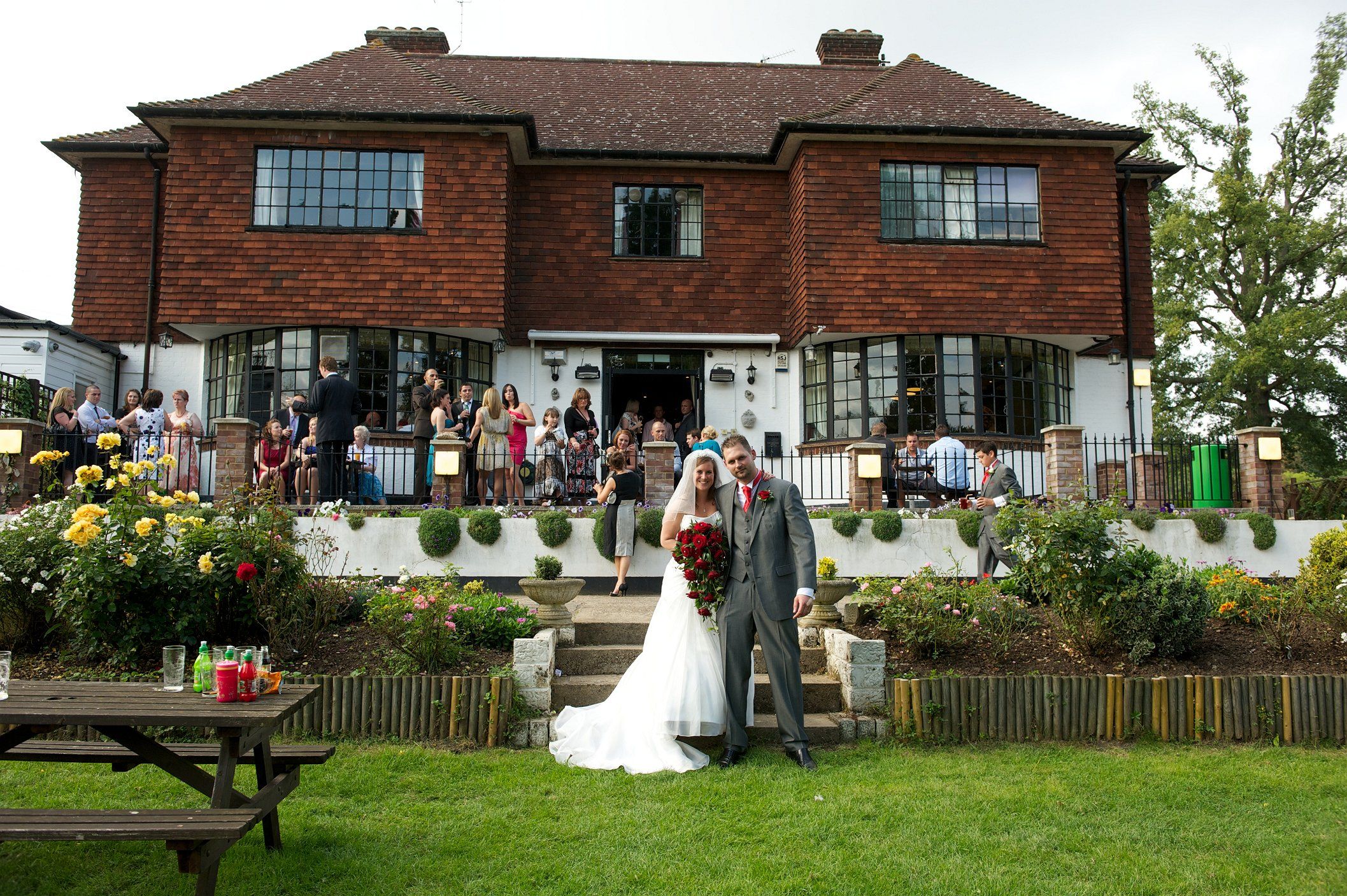 Outdoor wedding venue at Surbiton Town Sports Club with lush garden and floral arrangements.