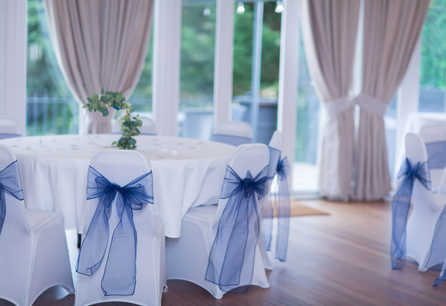 Elegant wedding venue with round tables and navy blue accents in Surbiton.
