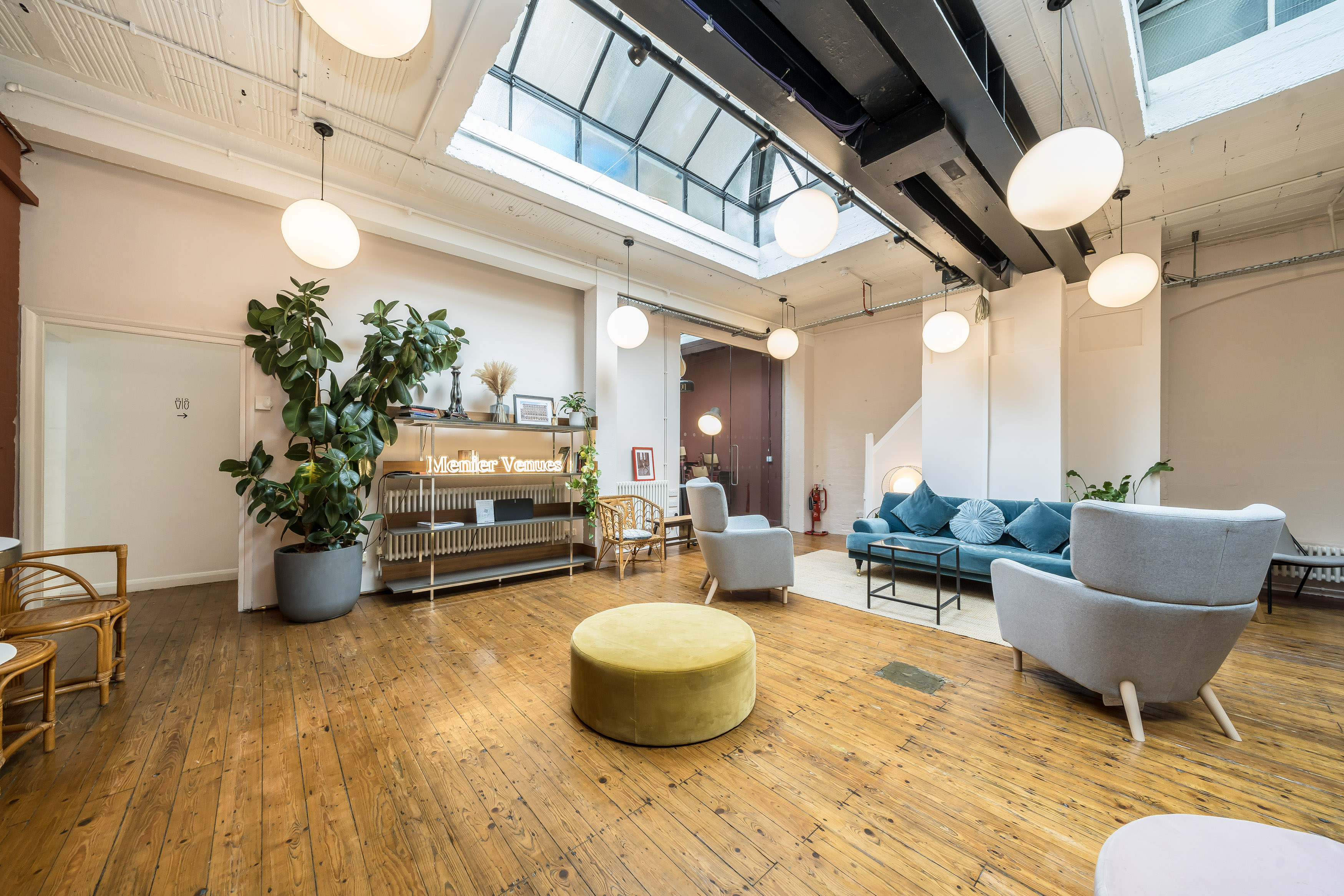 Stylish meeting space at Menier Playhouse with natural light and cozy seating for brainstorming.