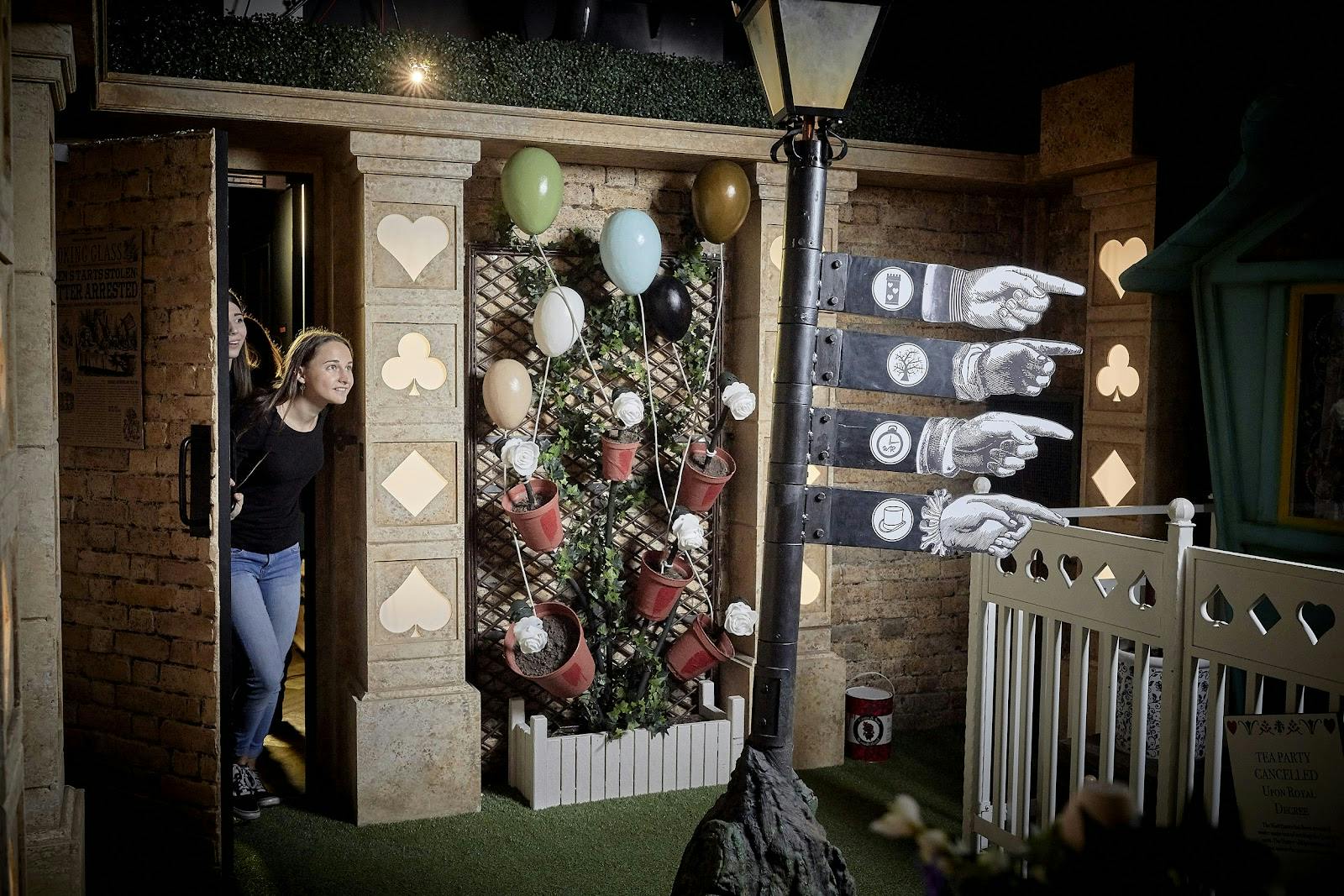 Whimsical entrance with balloons at Print & Play, Escape Hunt London for creative events.