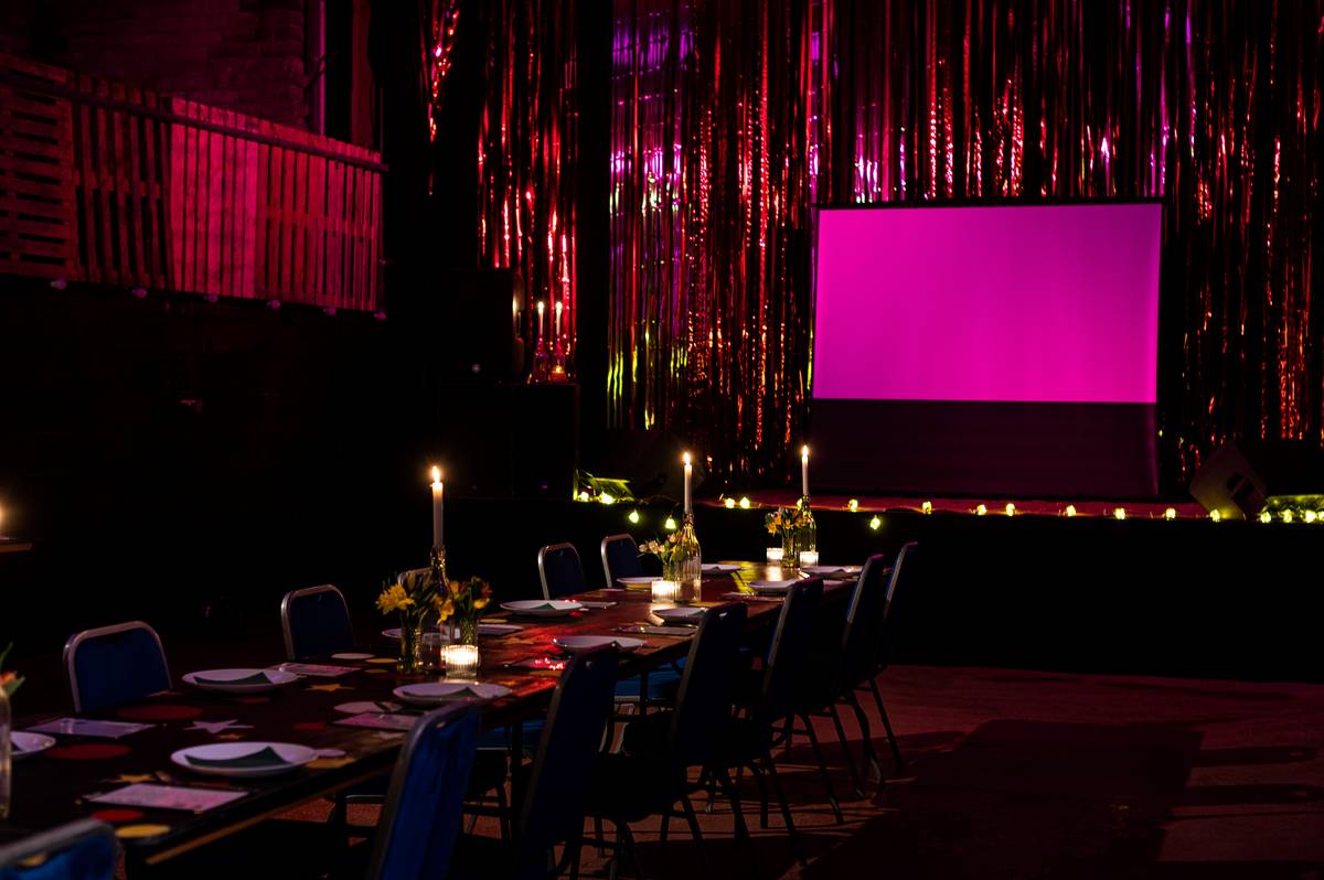 Elegant event space at Fairfield Social Club with candles and floral centerpieces.