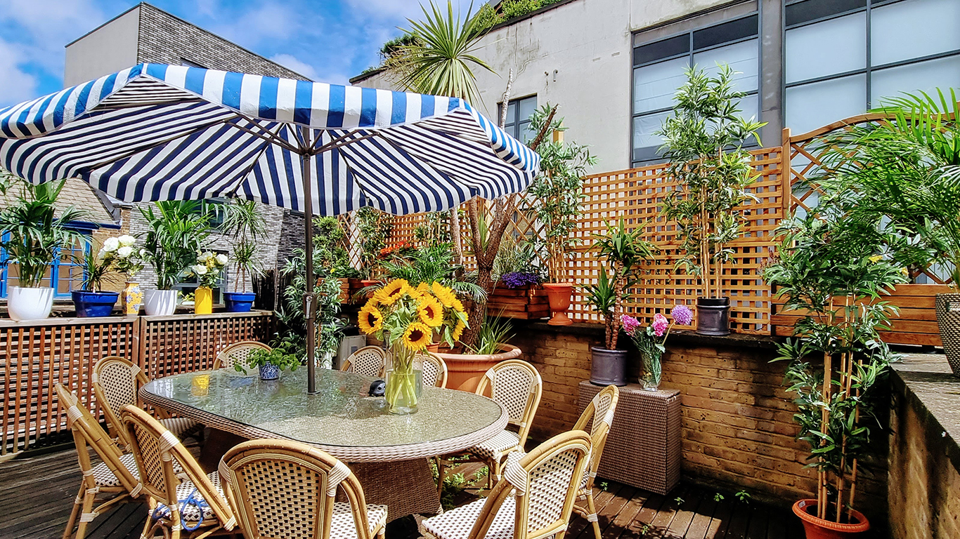 Outdoor venue in Lumiere London with striped umbrella, perfect for networking events.