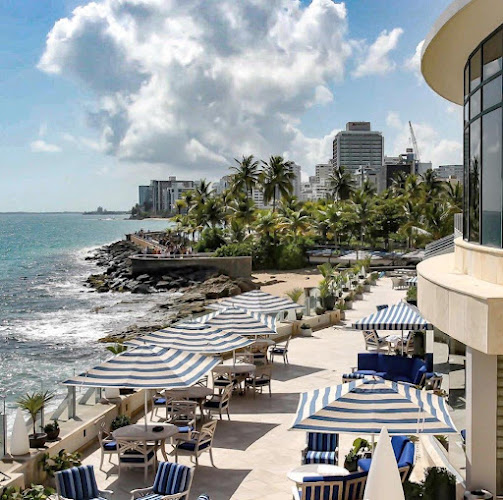 Laguna Terrace at Condado Vanderbilt Hotel: beachfront venue for events with palm trees.