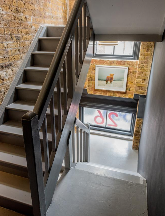 Well-lit staircase in event space at 26 Britton Street, perfect for networking and meetings.