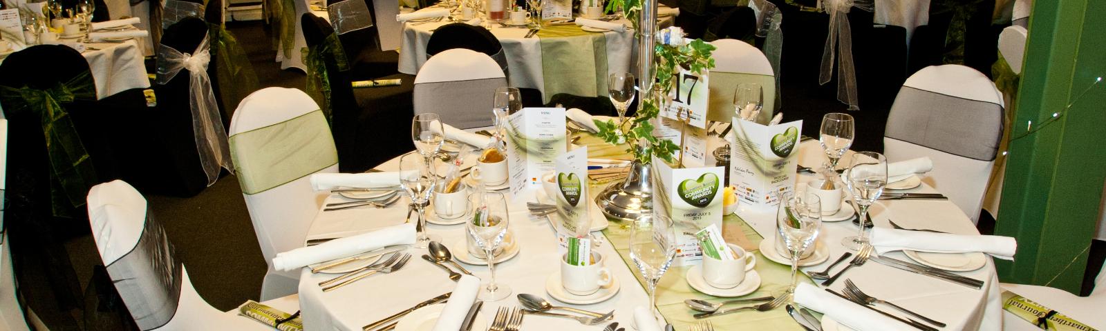 Elegant dining setup at Ffos Las Racecourse for corporate events, featuring refined décor and menus.