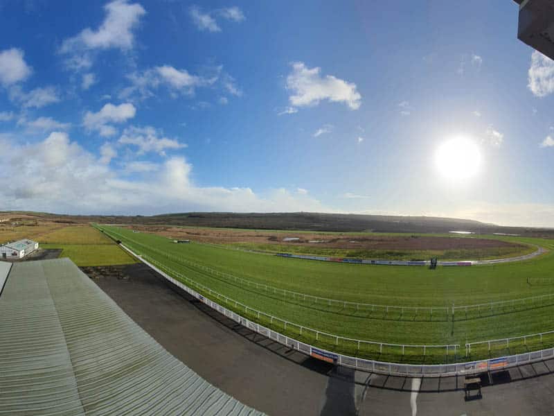 Corporate hire at Ffos Las Racecourse, featuring a lush green racetrack for events.