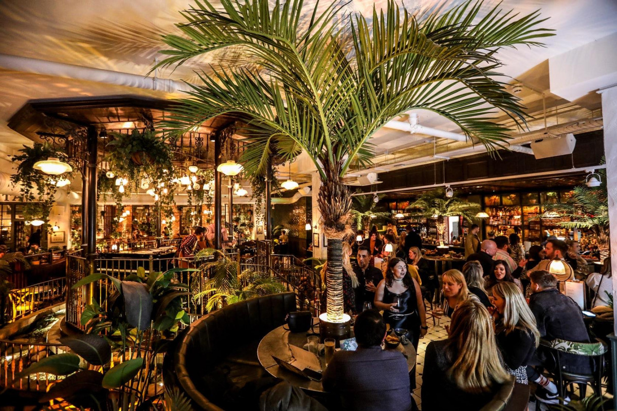 Private dining room at The Botanist Cardiff, lush greenery, ideal for intimate events.