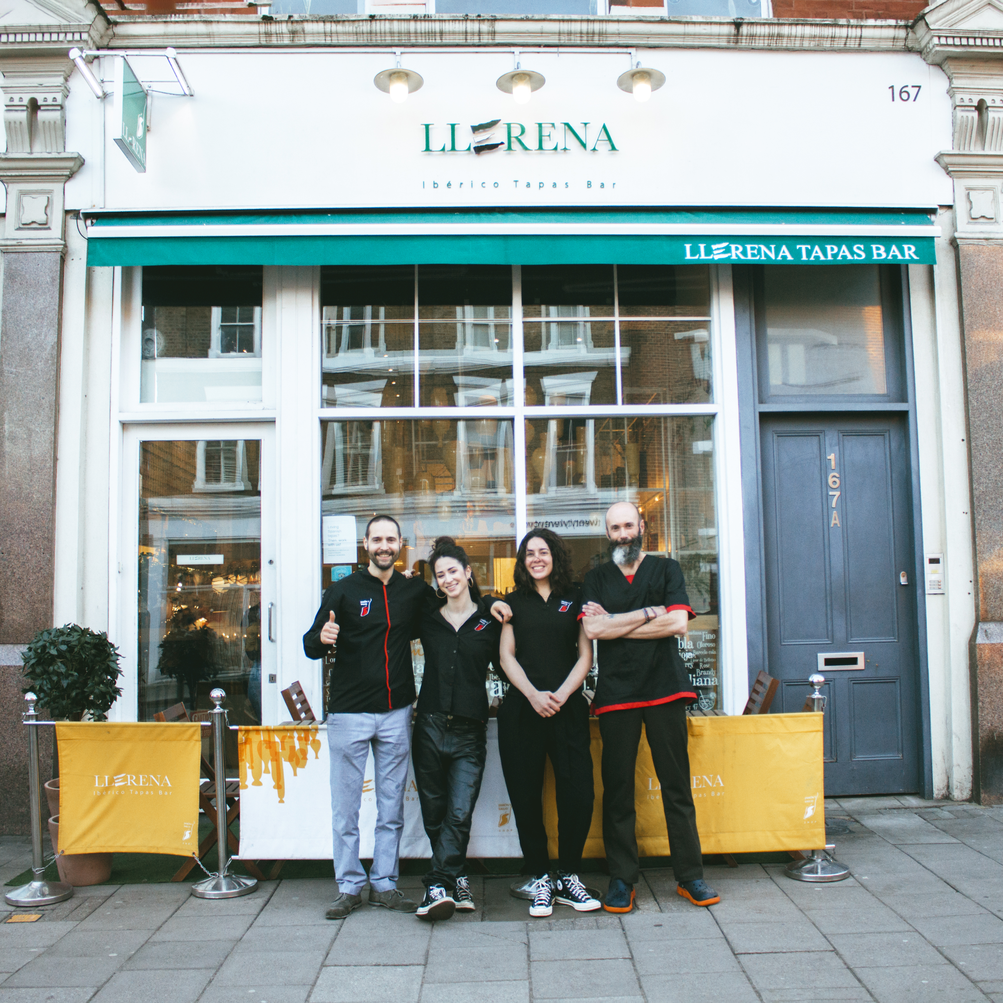 Team of four staff outside a vibrant tapas bar in Llerena, perfect for casual events.
