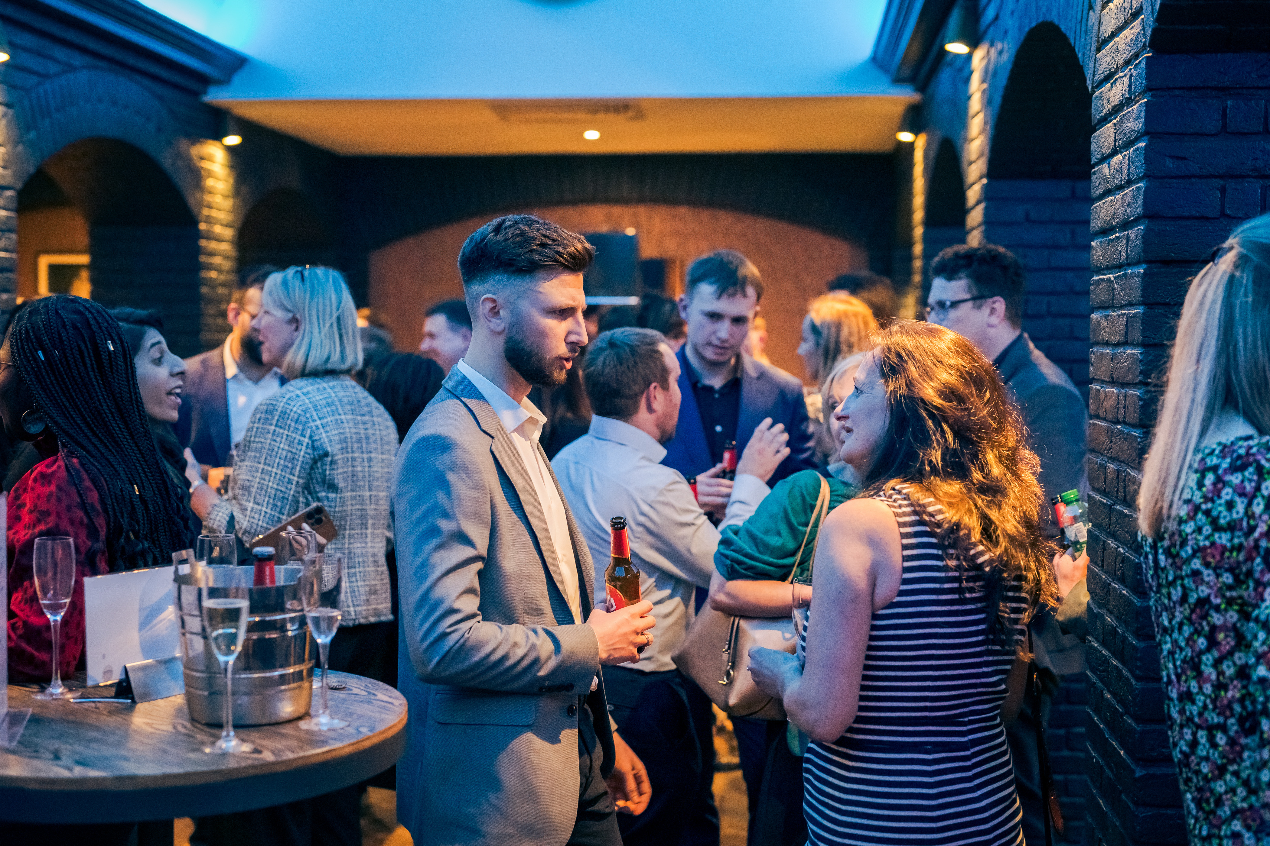 Vibrant networking event at Grubstreet Cellars with modern decor and lively ambiance.