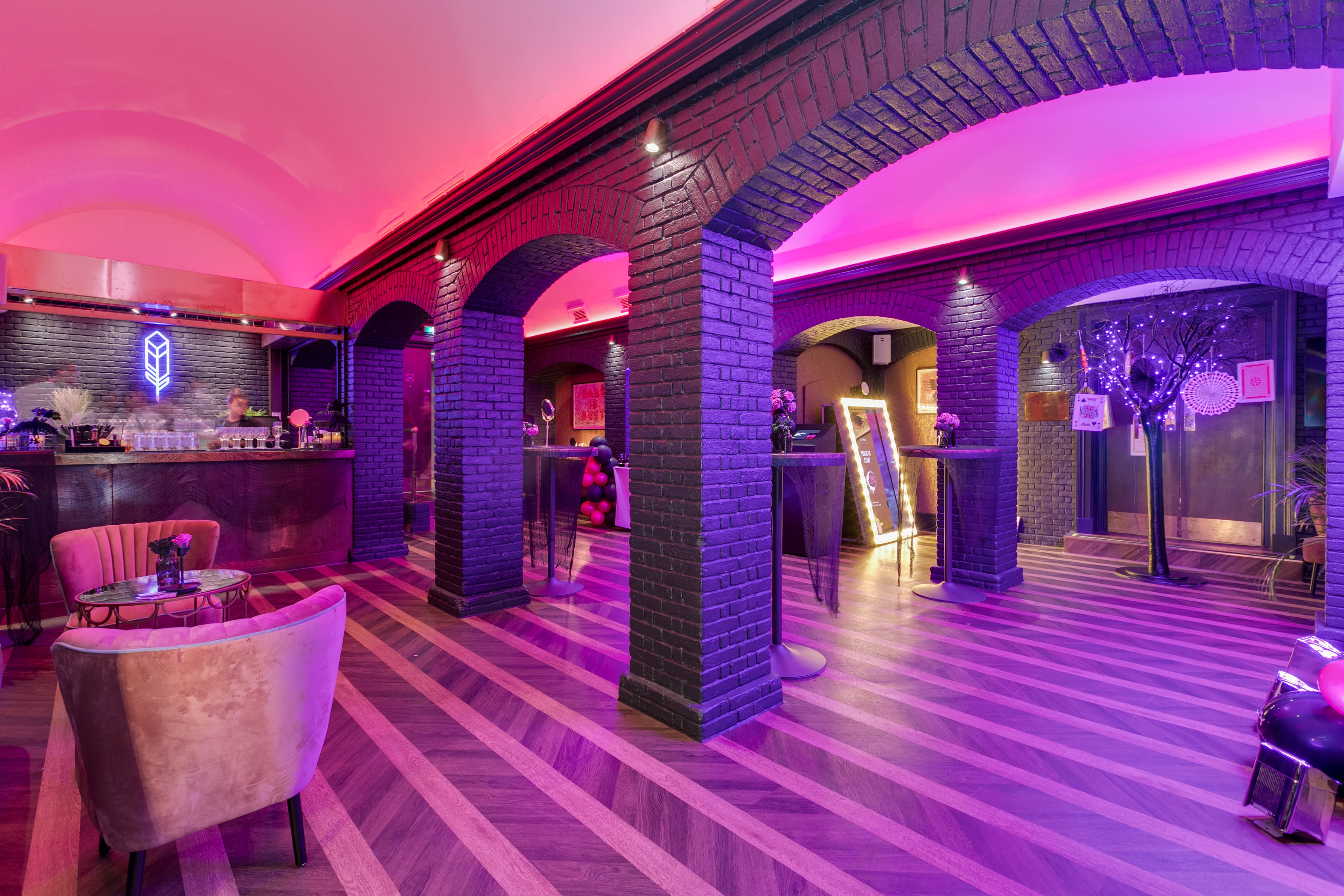 Grubstreet Cellars event space with elegant arches and ambient purple lighting.