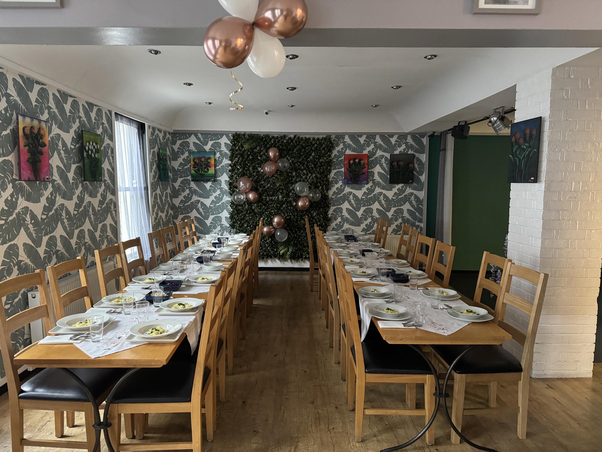 Elegant function room with long table, perfect for meetings and celebrations.