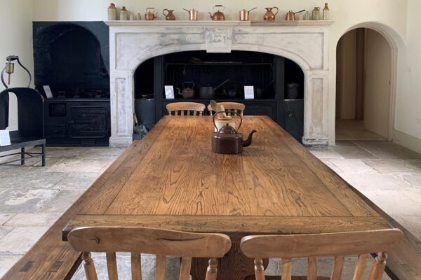 Holcombe Room at Valentines Mansion: rustic meeting space with wooden table for gatherings.