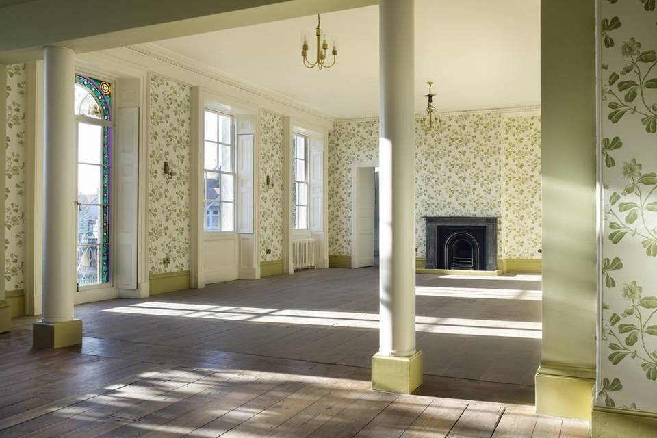Holcombe Room at Valentines Mansion: elegant event space with floral wallpaper and natural light.