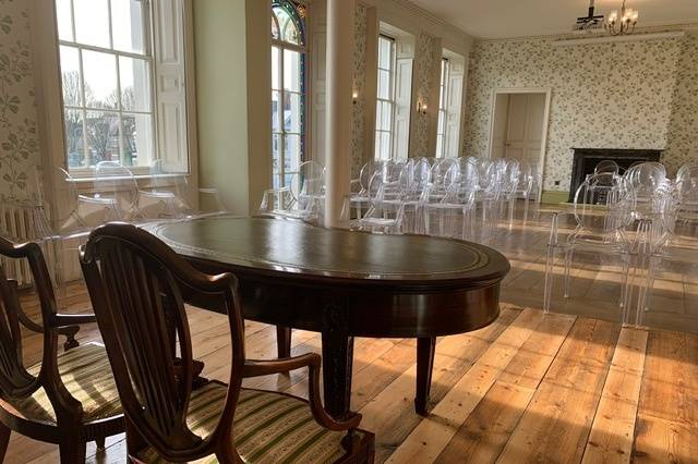 Holcombe Room at Valentines Mansion: elegant meeting space with polished table and chairs.