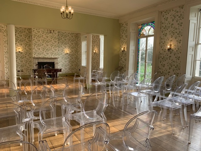 Modern meeting space with transparent chairs in Valentine's Mansion for workshops and gatherings.