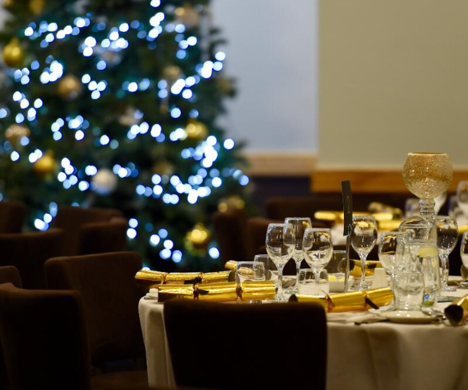 Elegant dining table with golden accents for Christmas parties at Uttoxeter Racecourse.