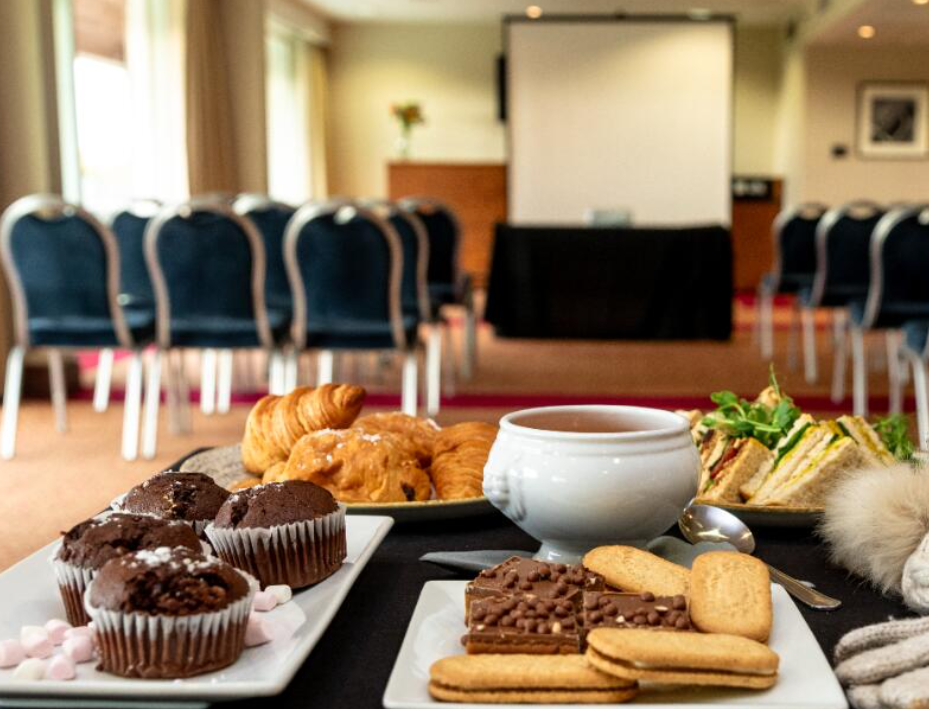 Refreshment station at Uttoxeter Racecourse with pastries and sandwiches, ideal for meetings.