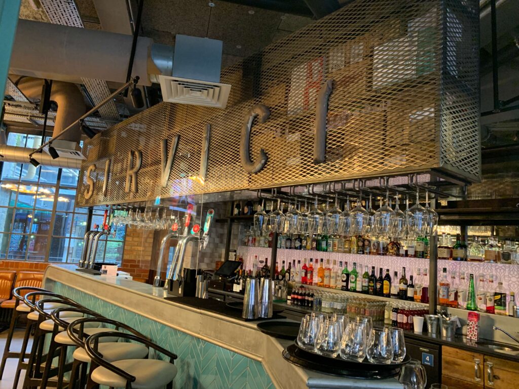 Stylish industrial bar at New Road Hotel, perfect for networking events and cocktail receptions.