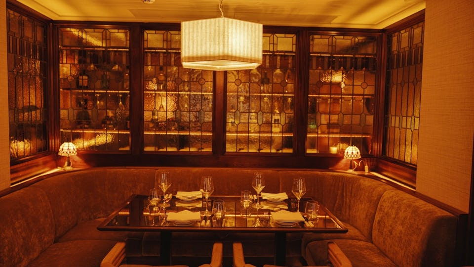 Intimate dining space with plush seating for corporate dinners and exclusive events.