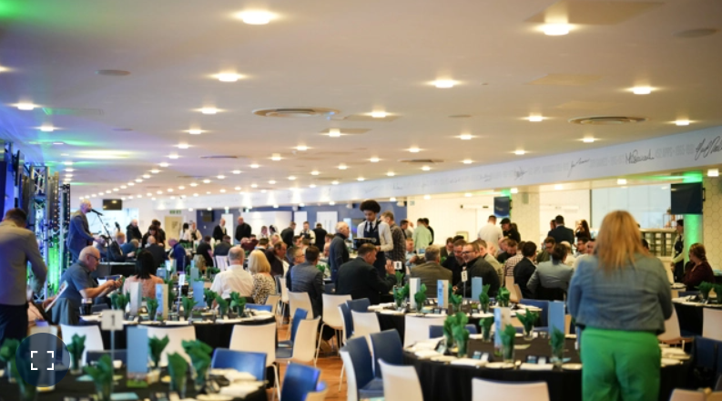 Vibrant Manchester event space with green accents for networking and social gatherings.