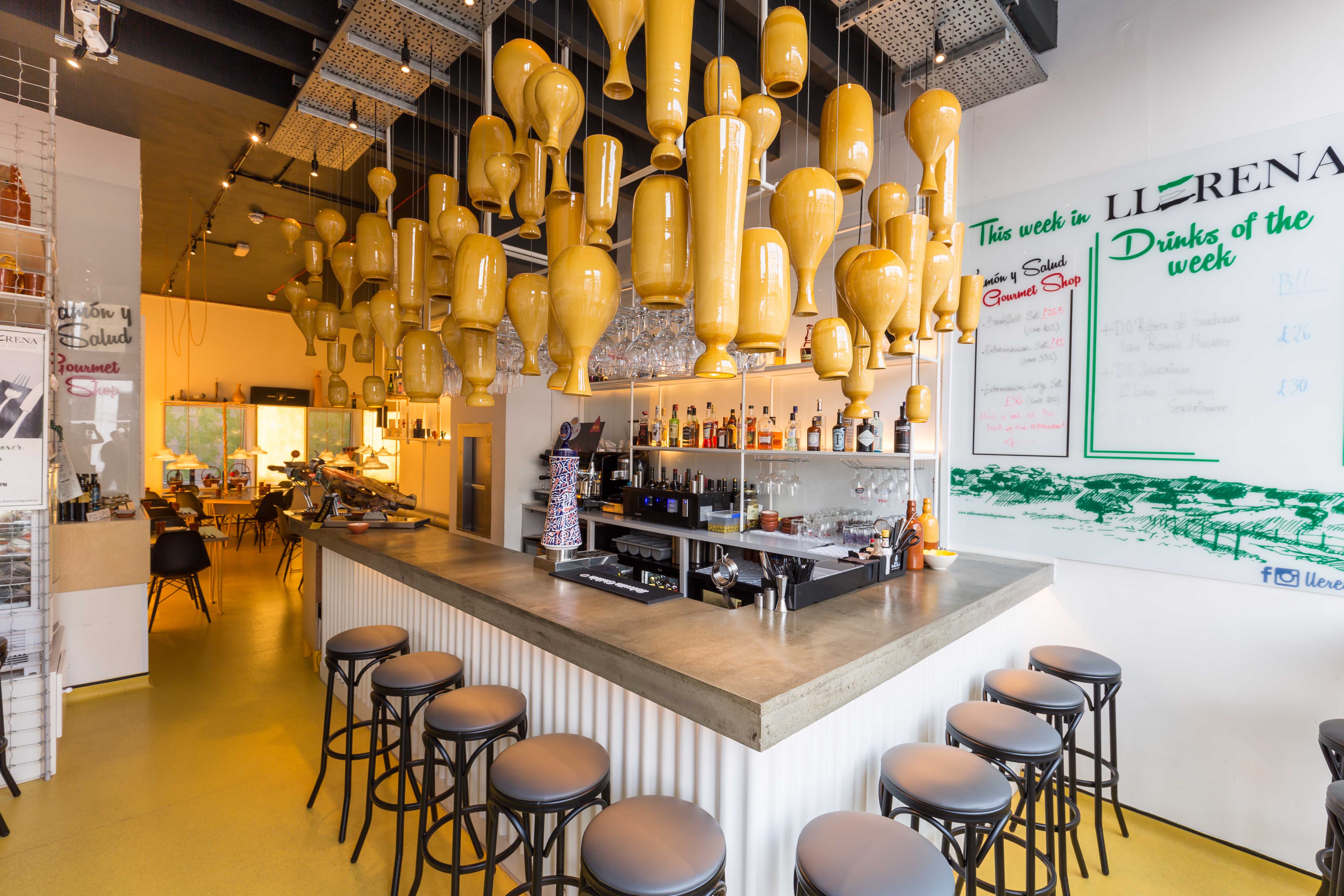 Modern bar area with unique pendant lighting, ideal for networking events and cocktail receptions.